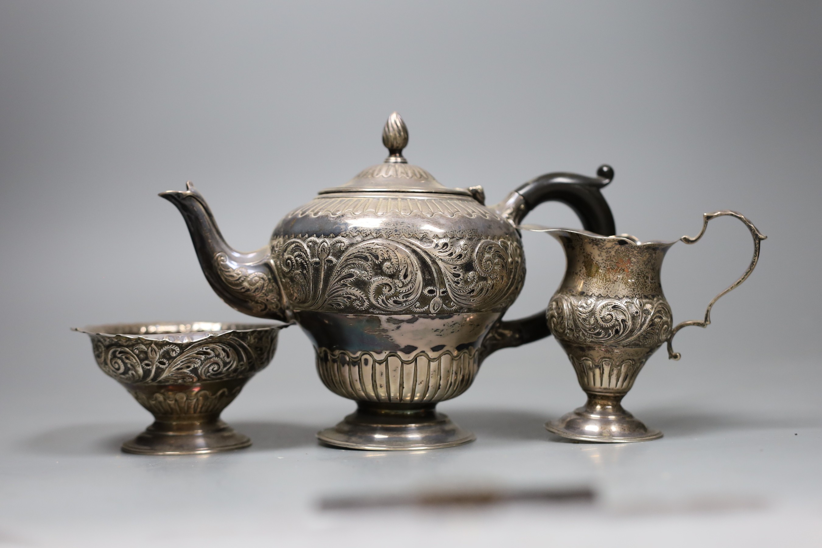 A Victorian three piece silver bachelor's teaset, London 1883, gross 14.5 oz.